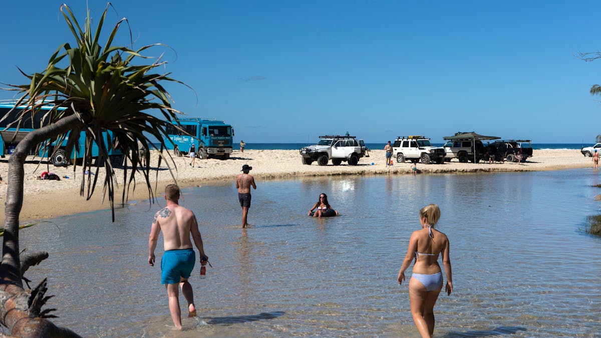 Photo showing people walking in shallow water at Eli Creek on Fraser Island.