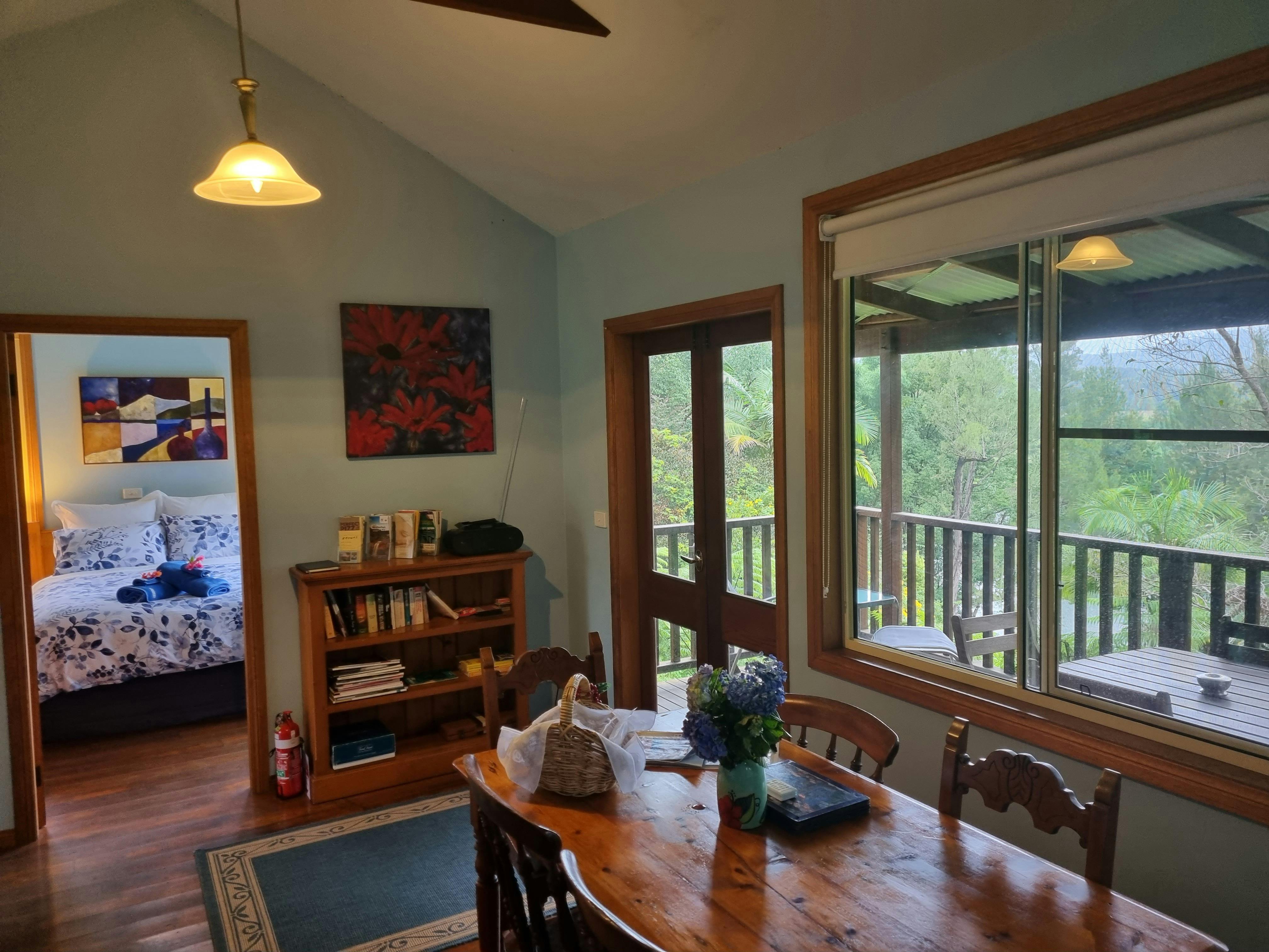 View looking from living space to outside verandah overlooking river