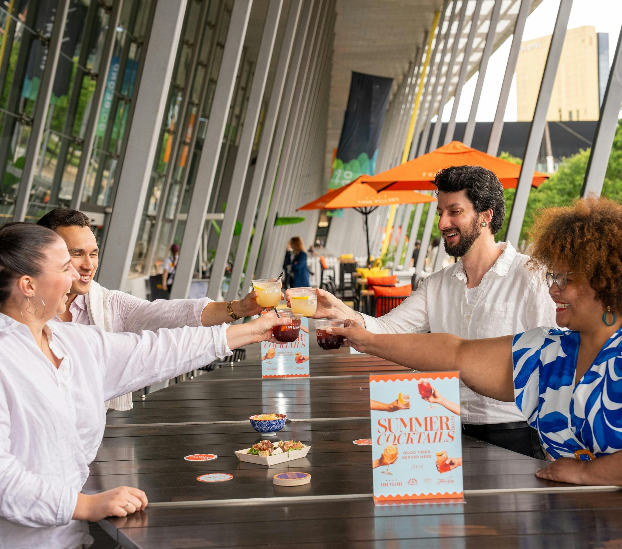 A group of friends enjoying cocktails at Summer at the Shed pop-up bar