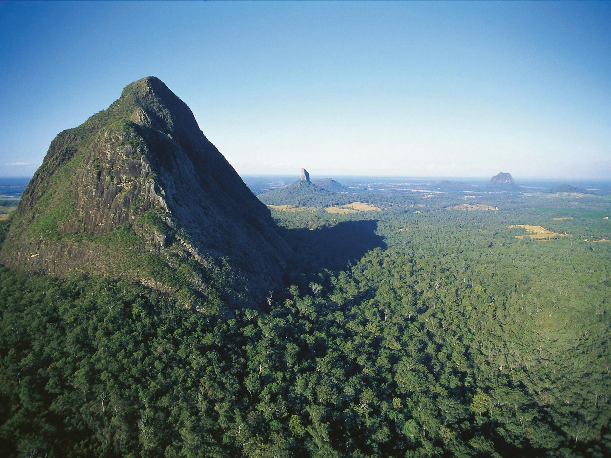 Mount Beerwah rising above surrounding forest. Mount Beerwah rising above surrounding forest.