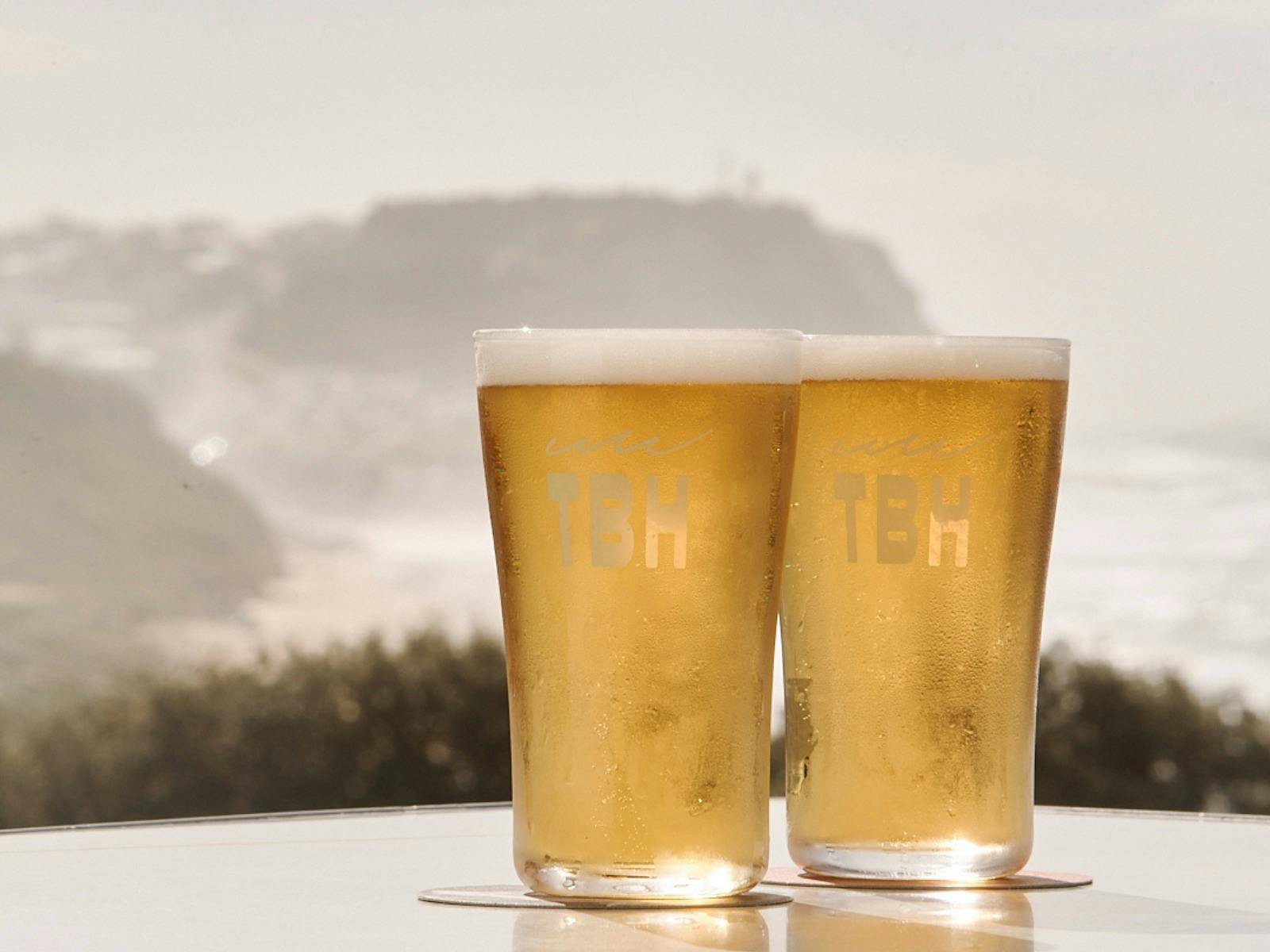 Two Schooners of beer with a Merewether Beach View