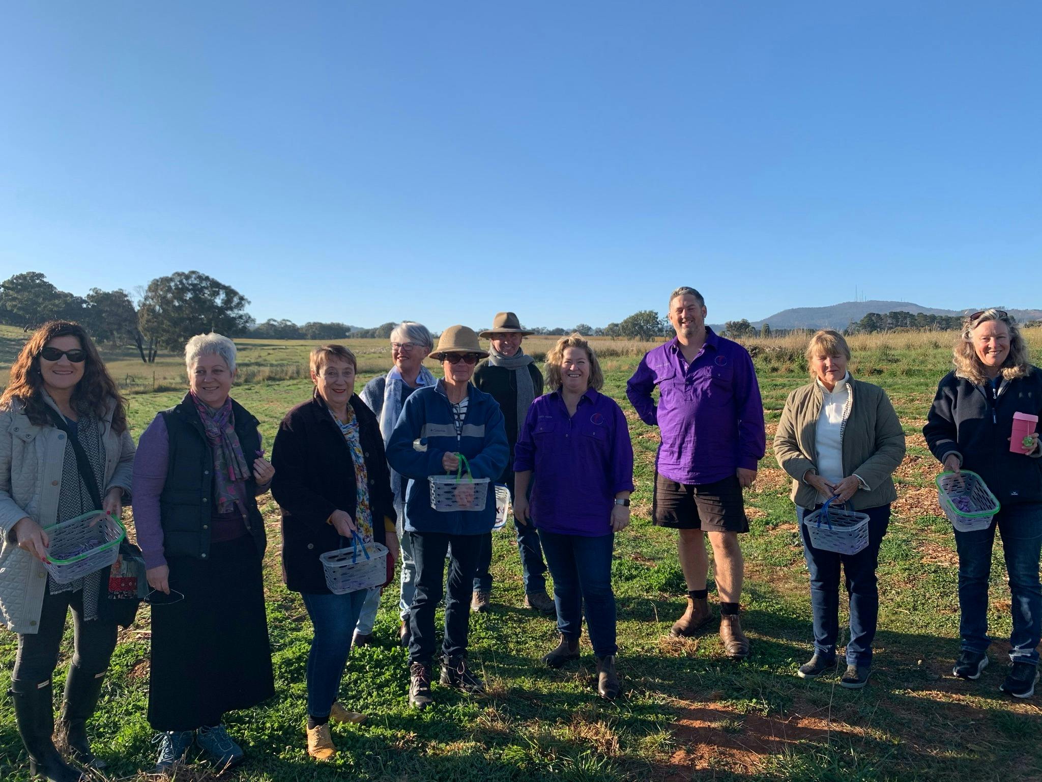 10 people standing in saffron paddock