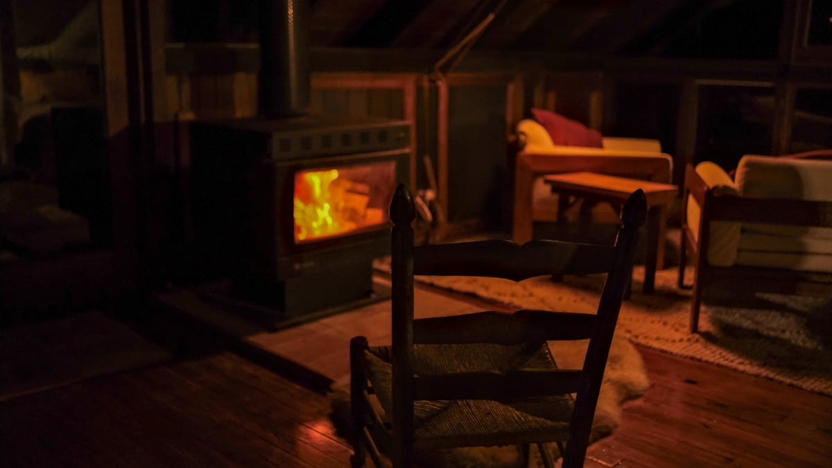 Indoor fireplace with vintage rocking chair and warm furnishings