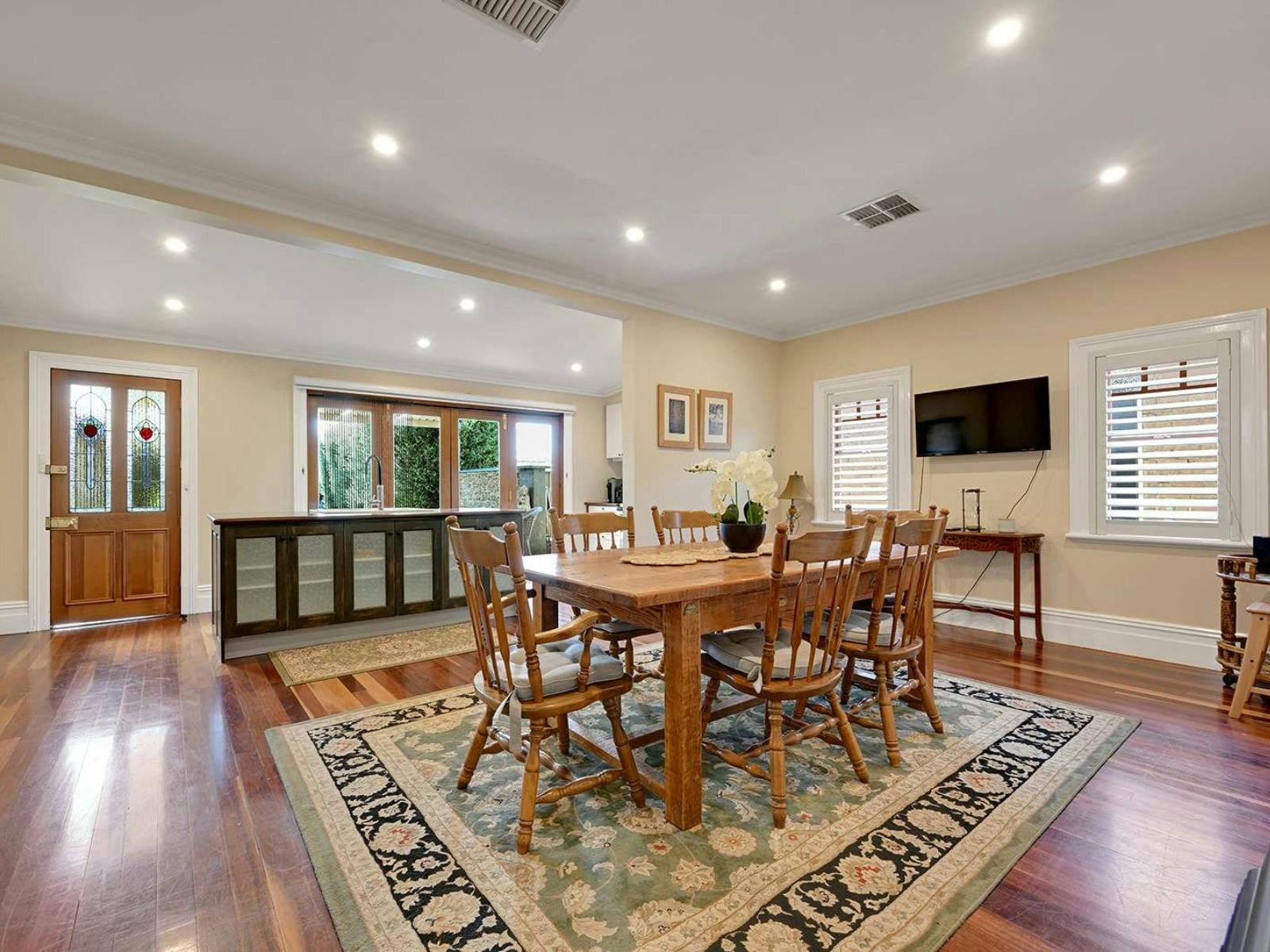 Wooden dining table and chairs with a rug