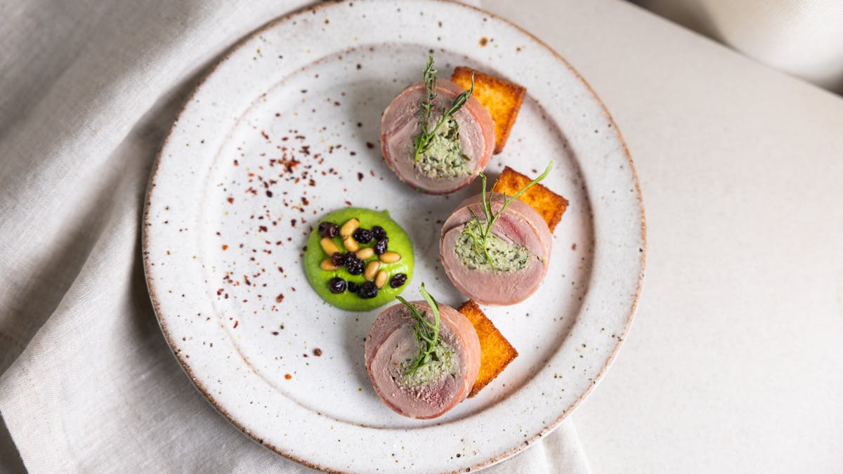 Quail Ballotine, Polenta, Herb Emulsion, Pickled Currants, Pinenuts