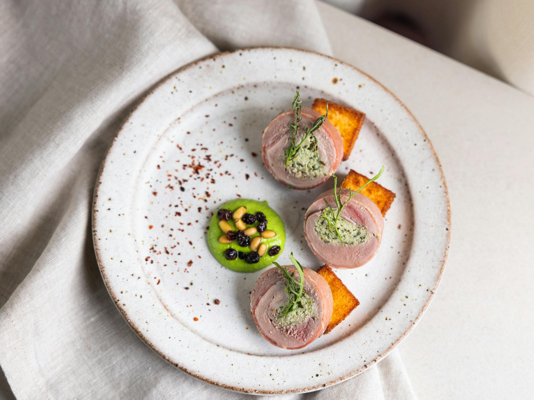 Quail Ballotine, Polenta, Herb Emulsion, Pickled Currants, Pinenuts Quail Ballotine, Polenta, Herb Emulsion, Pickled Currants, Pinenuts