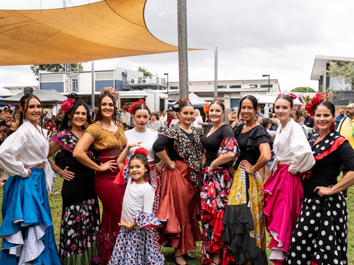 Women and girls dresses in Latin clothing perform at the Mareeba Multicultural Festival.