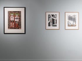 printmaking artworks on a pale green wall
