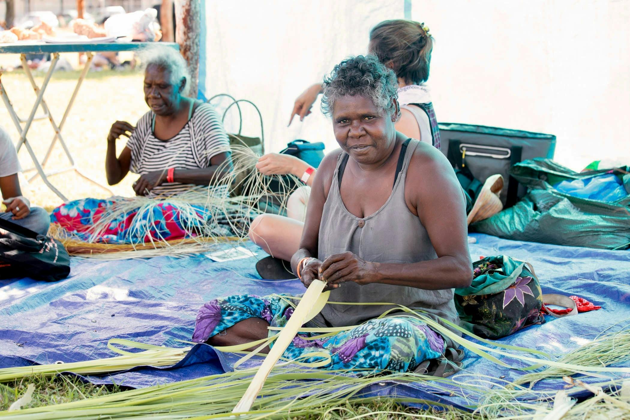 A woman weaving with pandanus