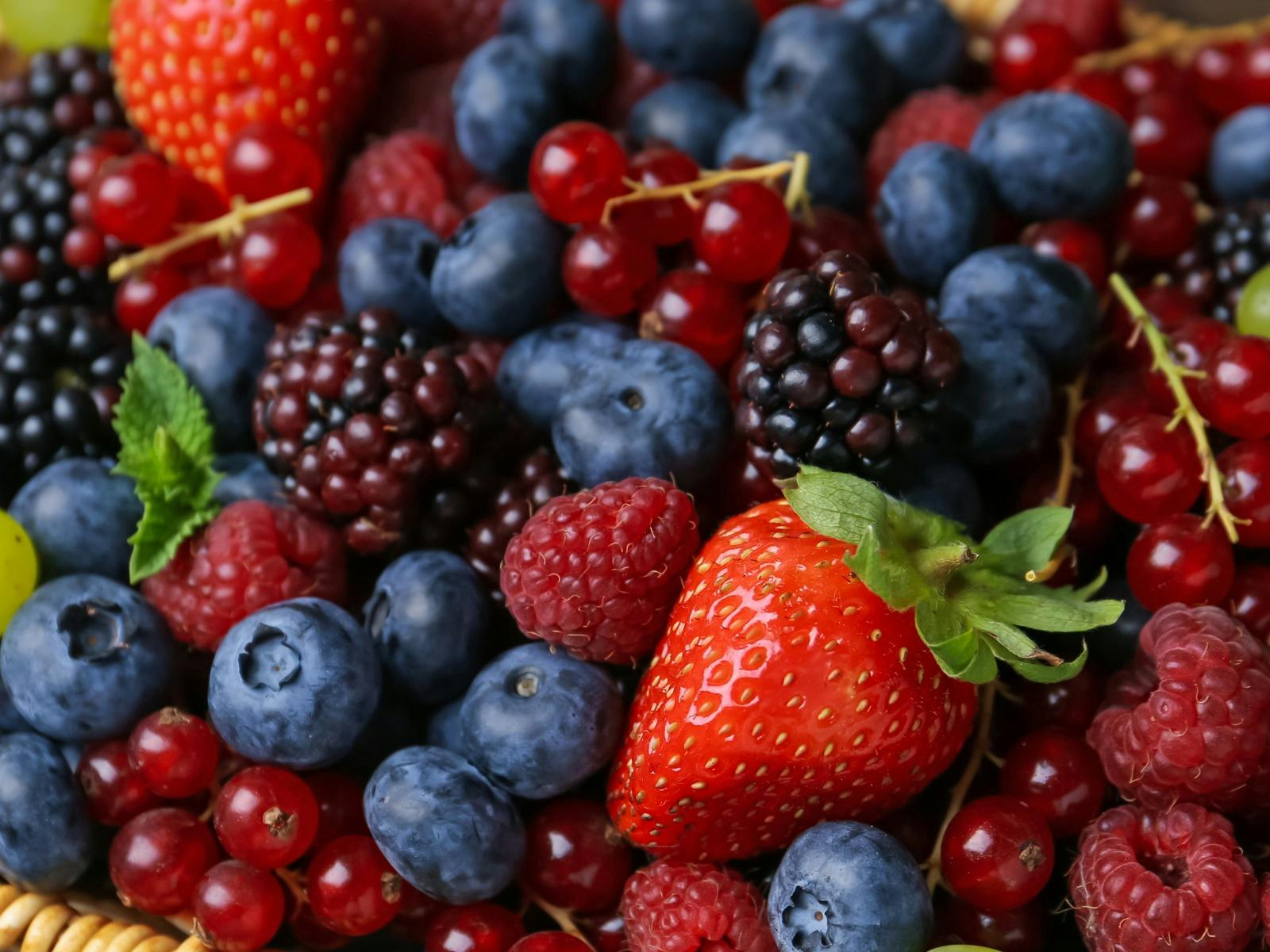 A vibrant basket of fresh summer berries.