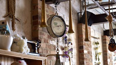 Quirky hanging objects from wooden beams and exposed brick walls