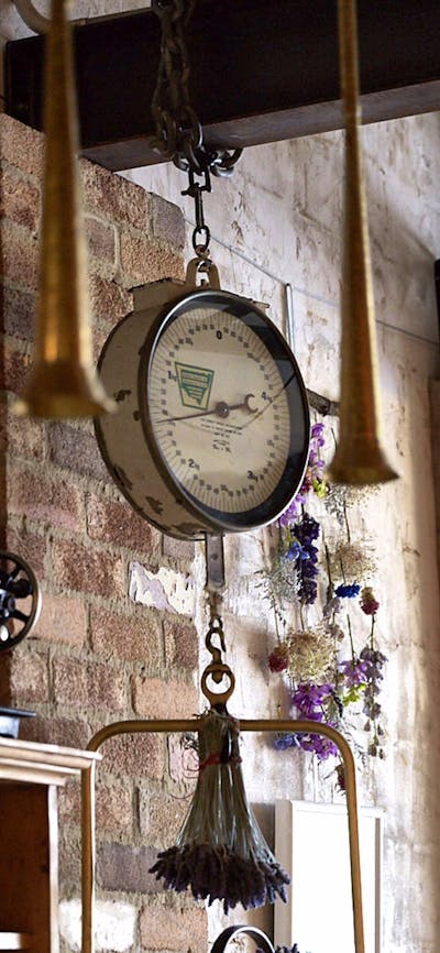 Quirky hanging objects from wooden beams and exposed brick walls