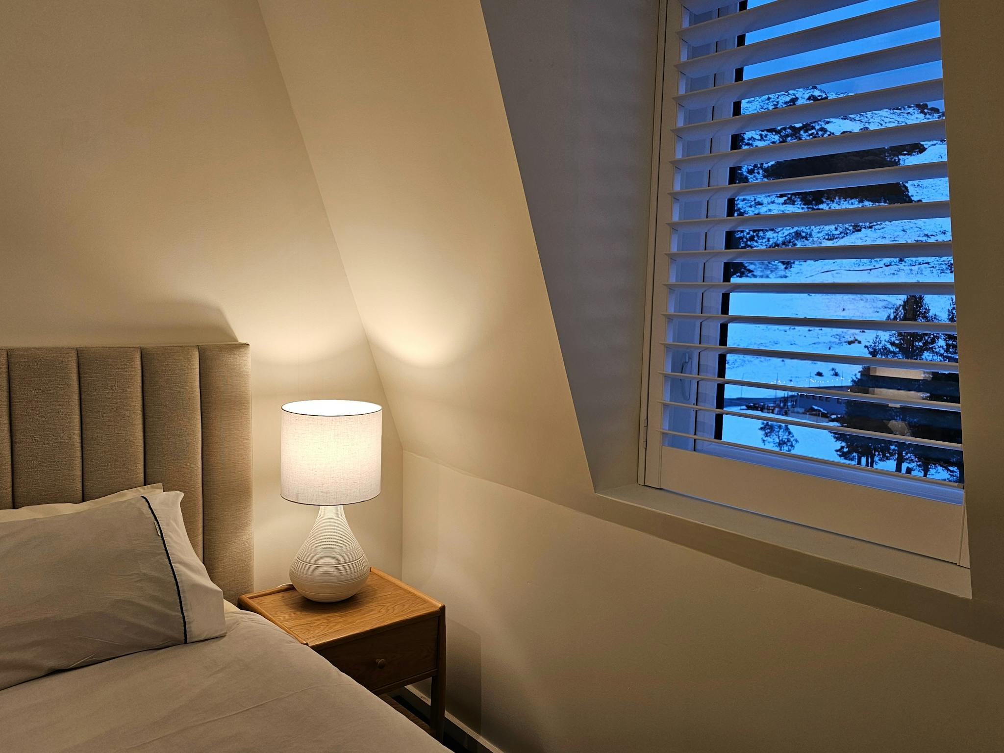 Cosy bedrooms with a table lamp and mountain views