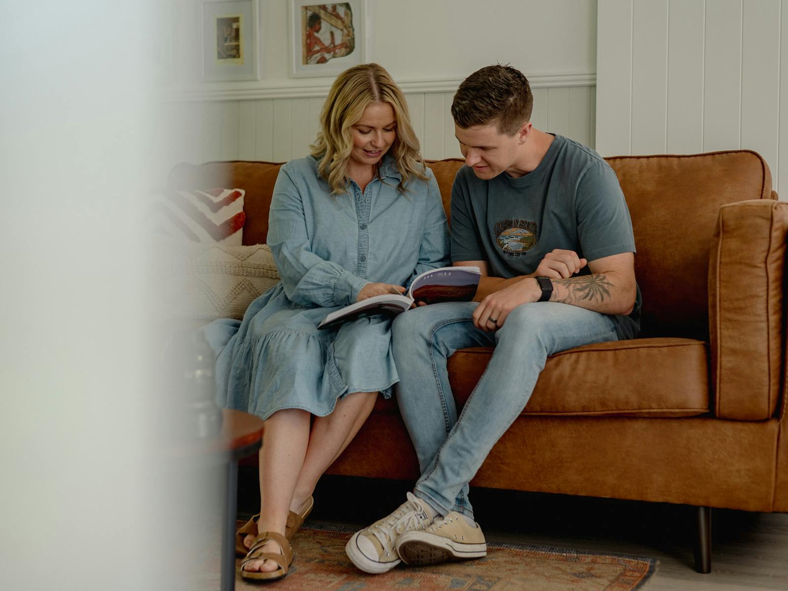 two people reading a magazine