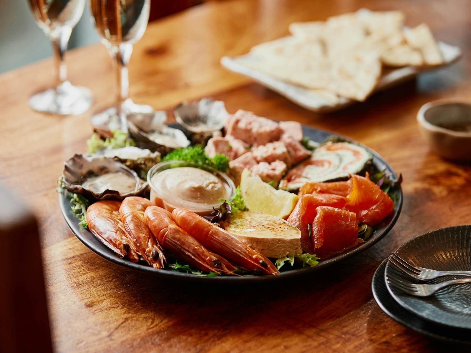A bowl of mixed gourmet seafood, including smoked salmon, prawns, terrine, roulade, oysters and more