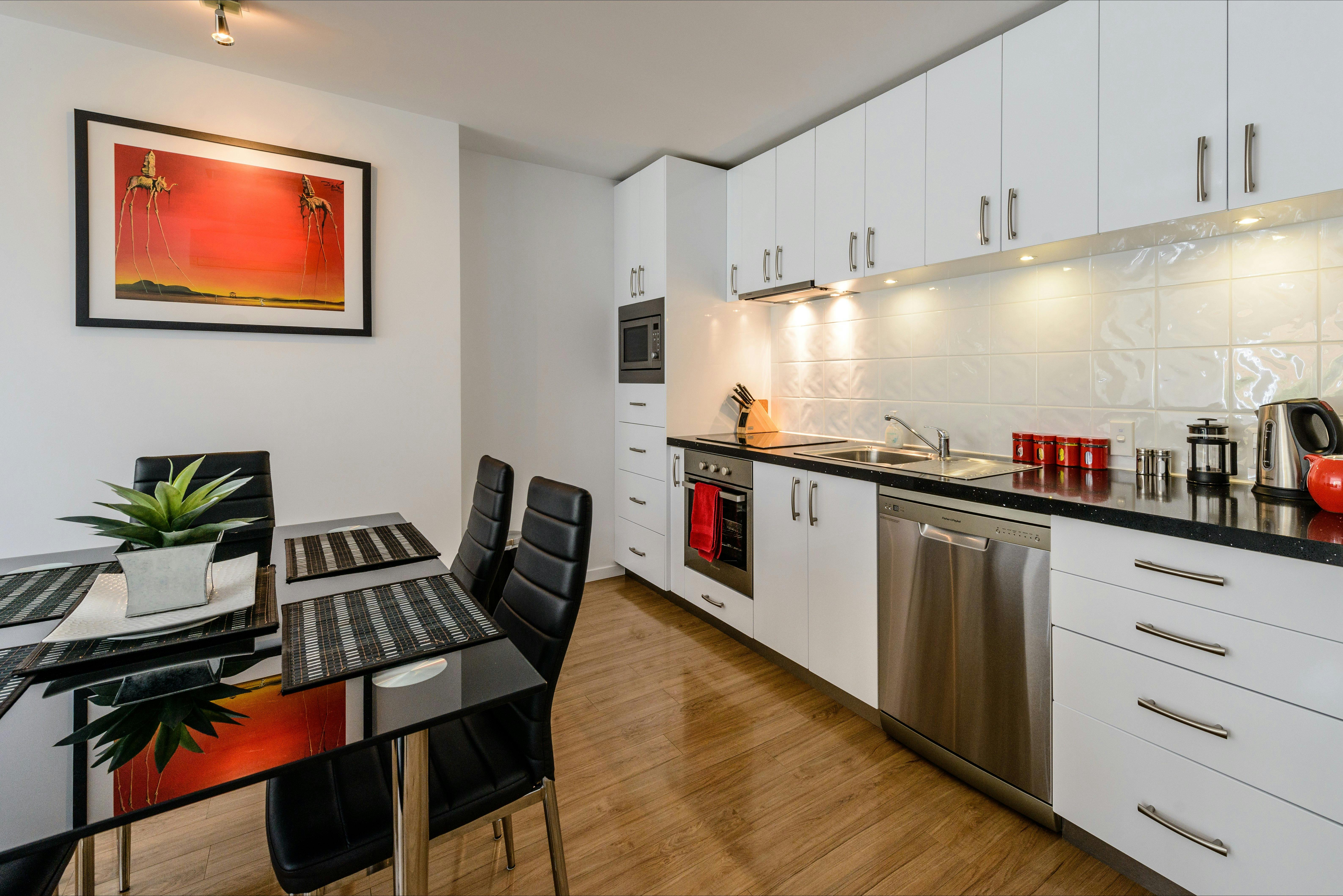 Fully equipped kitchen with modern appliances and adjoining dining area