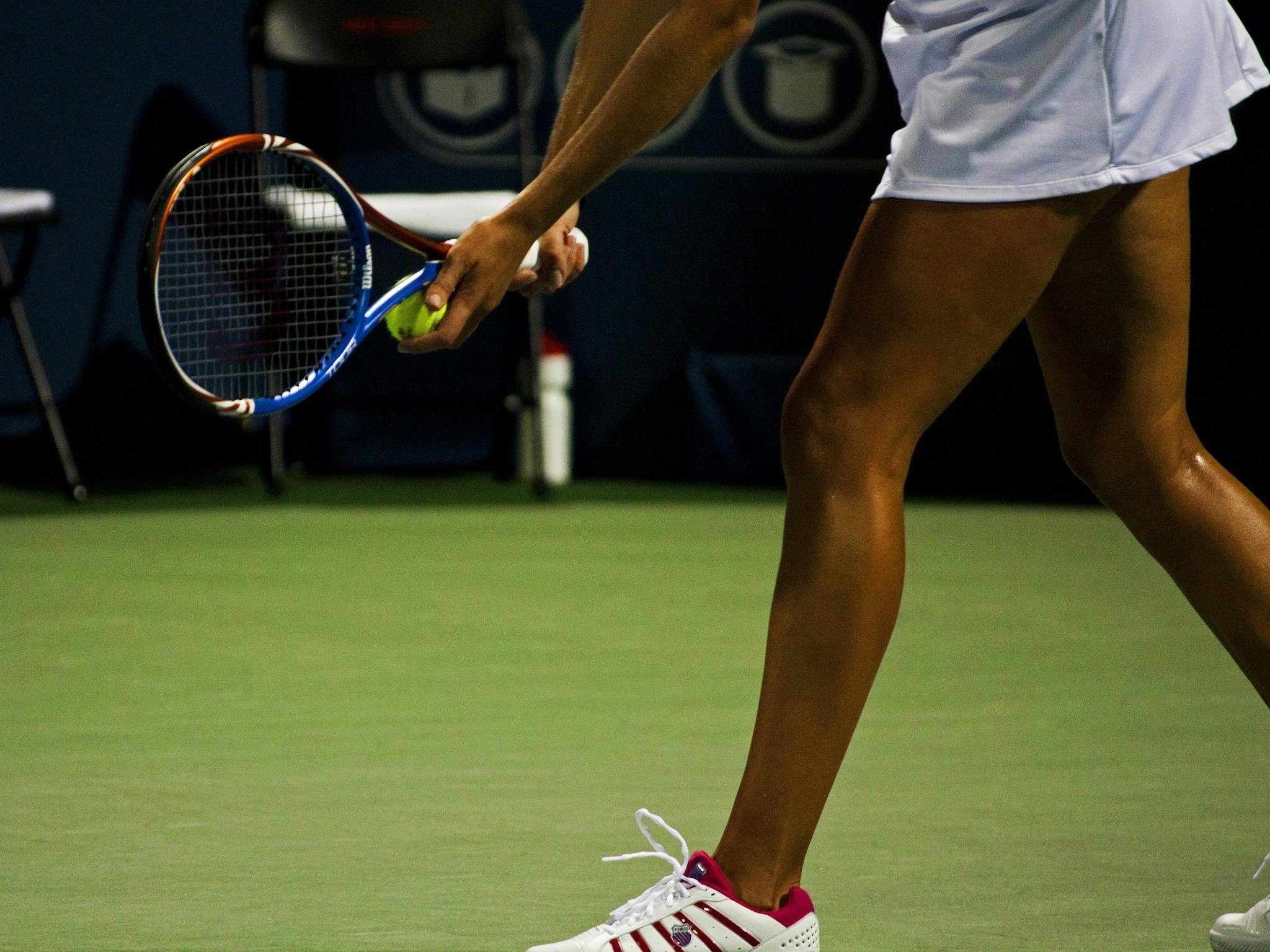 A female tennis player ready to serve