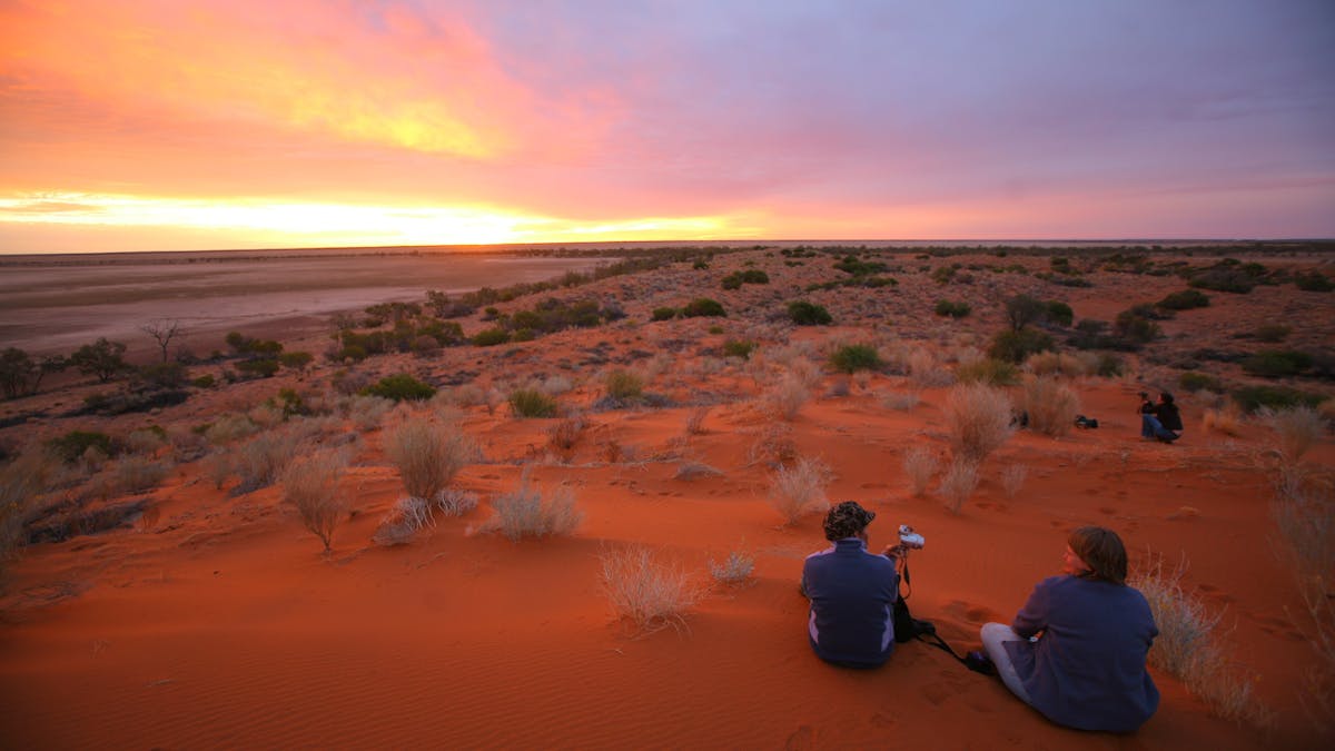 Visitors enjoying Diamantina's red sand hills and sunset. Visitors enjoying Diamantina's red sand hills and sunset.
