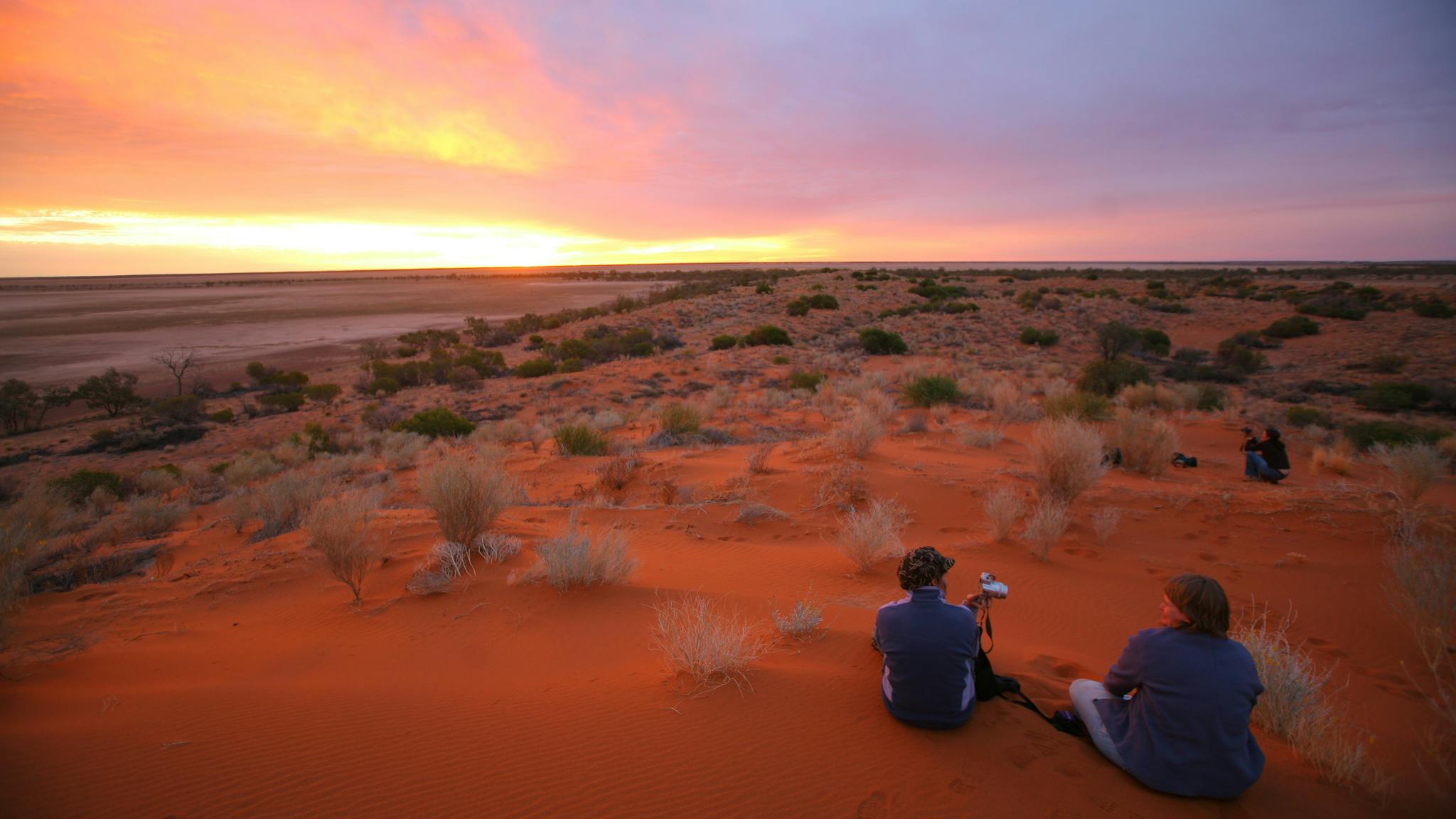 Visitors enjoying Diamantina's red sand hills and sunset. Visitors enjoying Diamantina's red sand hills and sunset.
