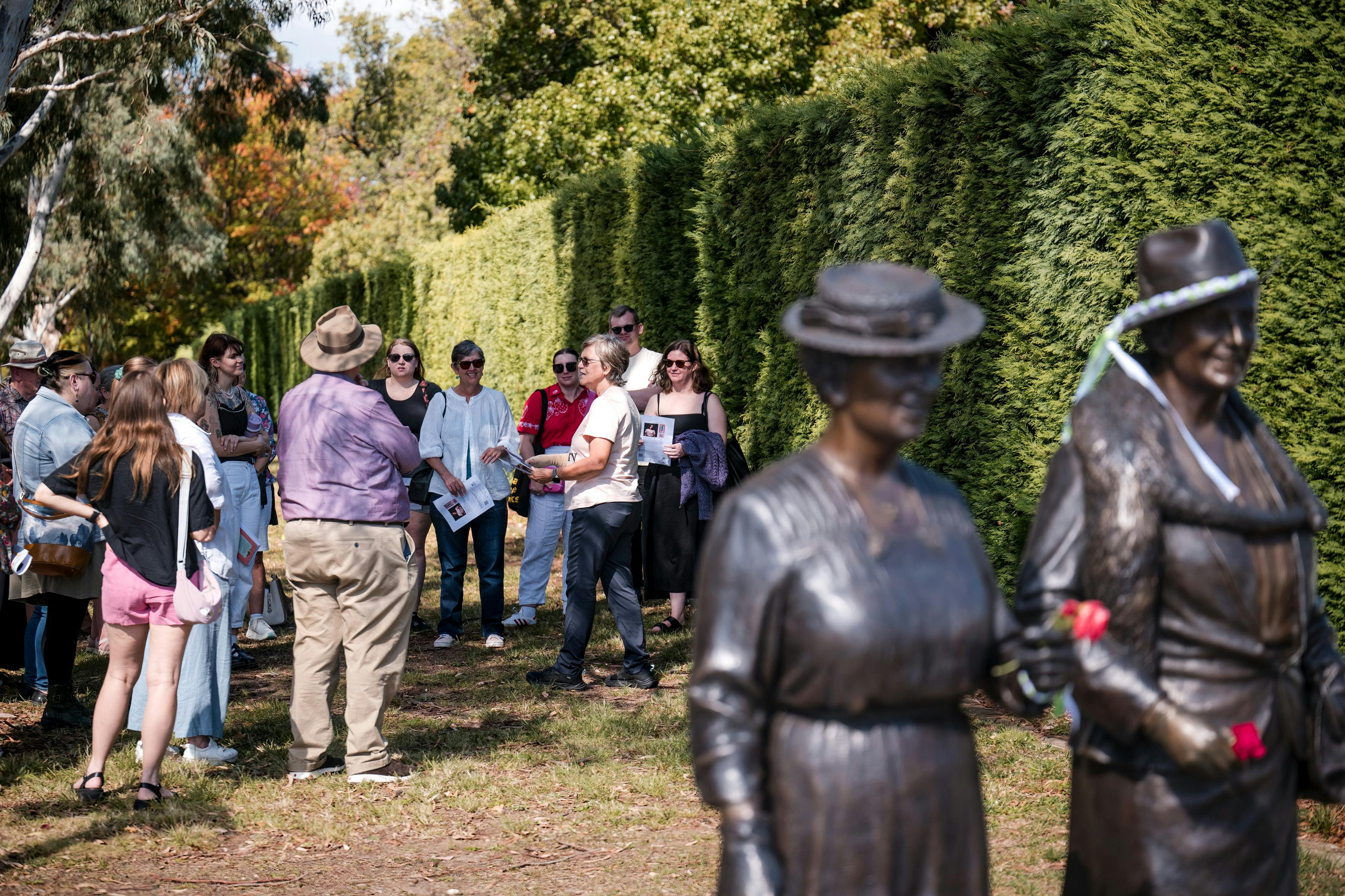 She Shapes History tour guide presenting to the group of engaged guests