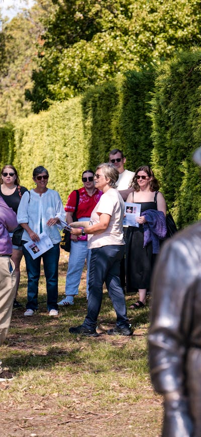She Shapes History tour guide presenting to the group of engaged guests