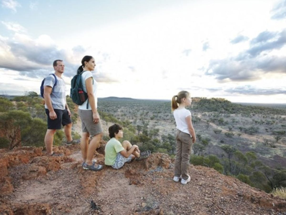 Man, Woman and Boy and Girl enjoy the view from Baldy Top, Quilpie Man, Woman and Boy and Girl enjoy the view from Baldy Top, Quilpie