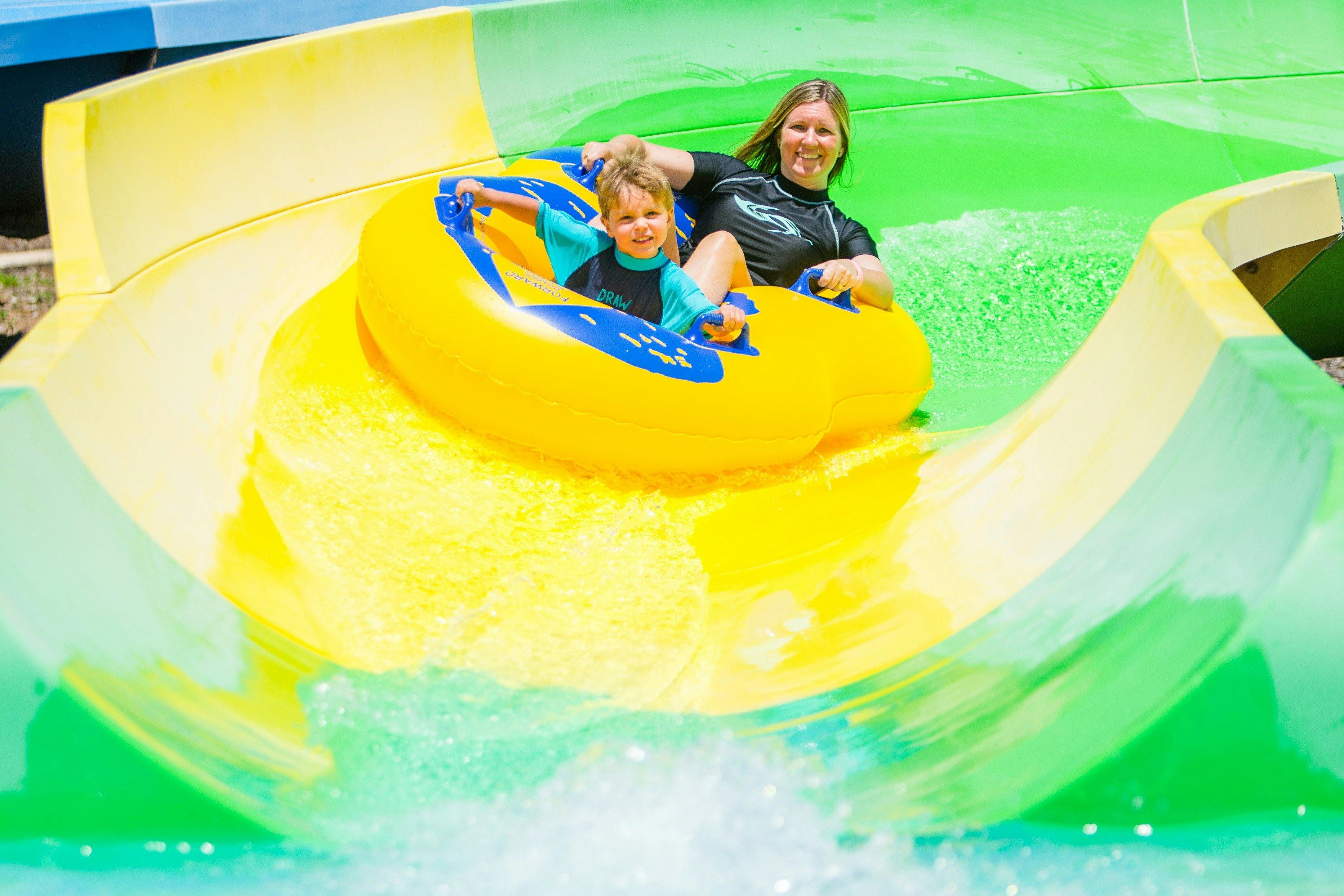 Mother and son on water slide