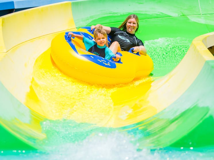 Mother and son on water slide