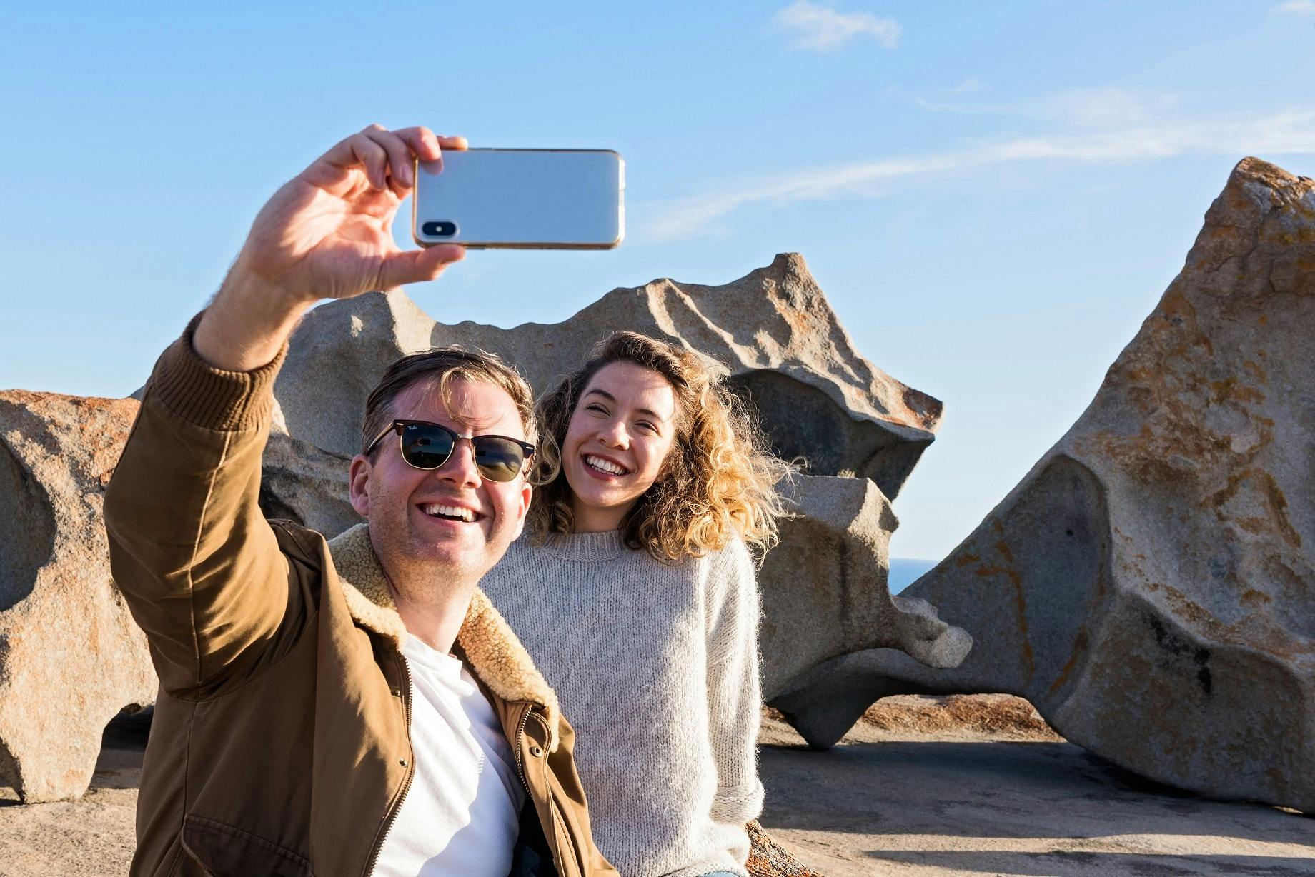Couple taking a selfie with Remarkable Rocks as the backdrop