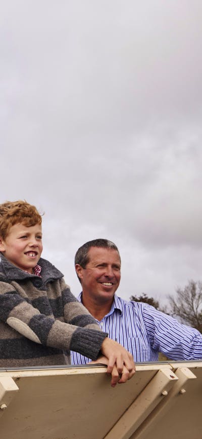 family looking with wind turbine in background