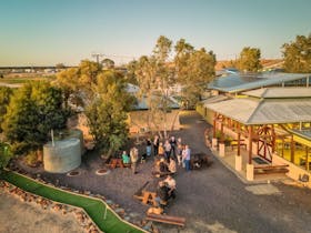 An aerial shot showing the exterior of the hotel and a crowd of patrons below.
