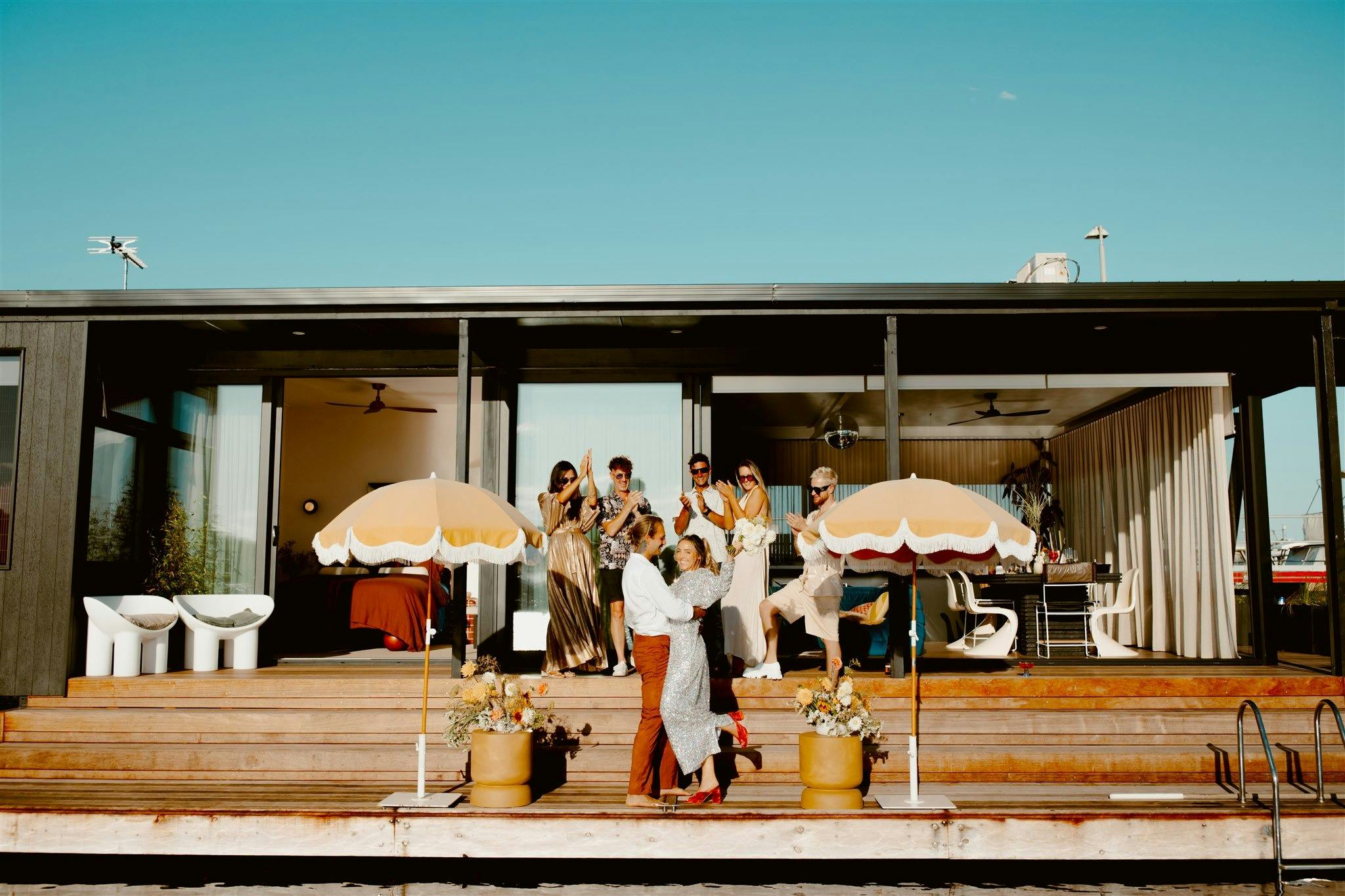 People cheering on the outdoor deck