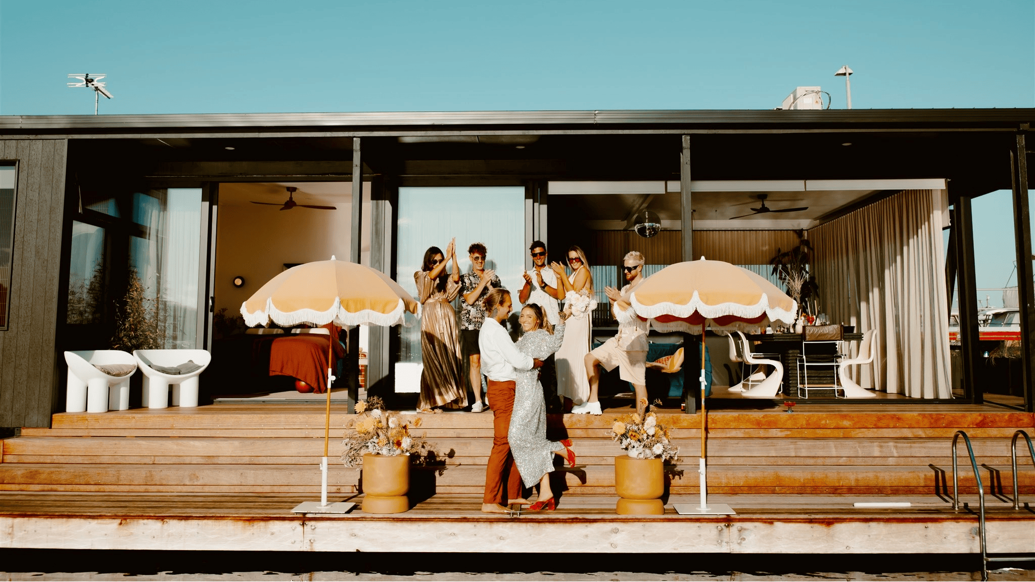 People cheering on the outdoor deck