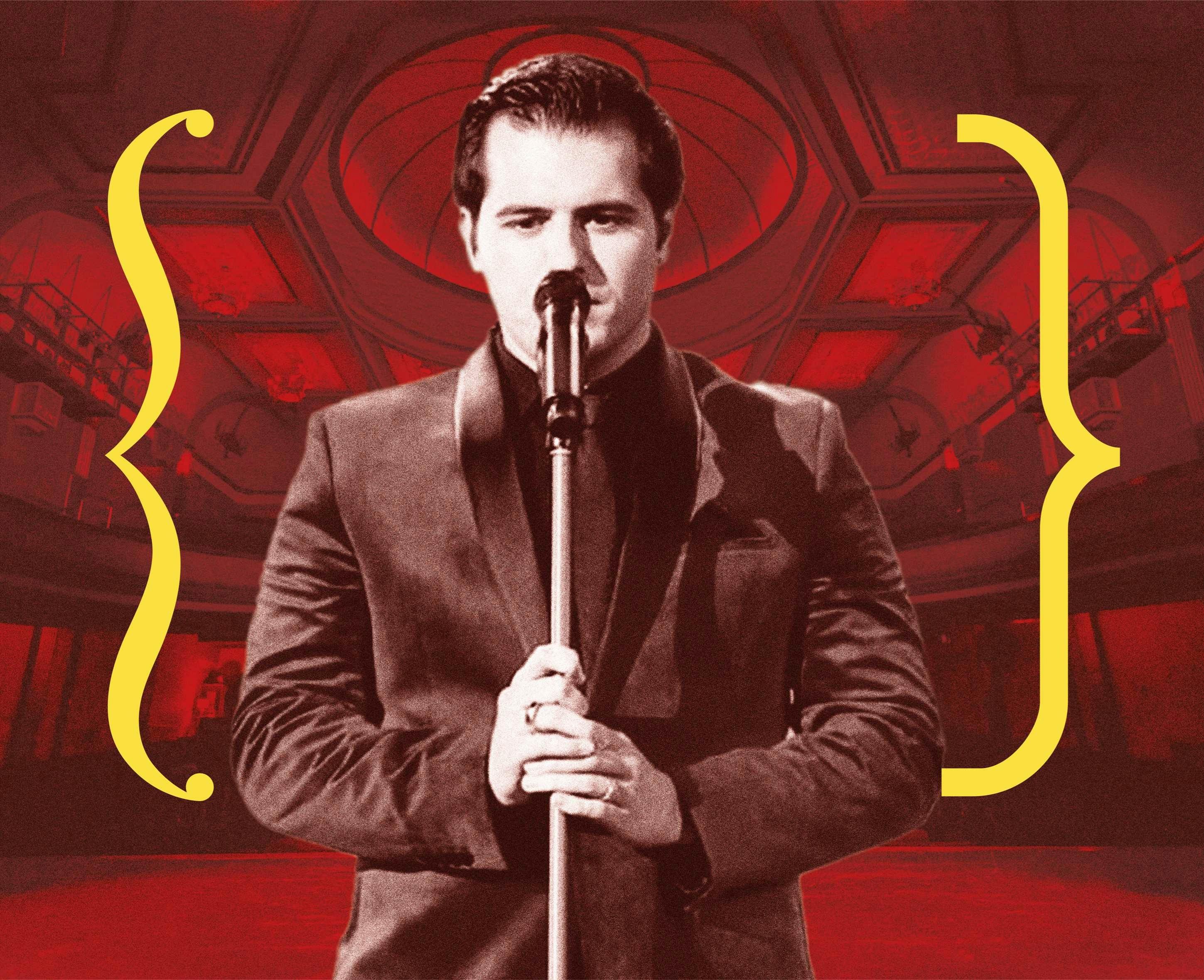A man sings into a microphone.