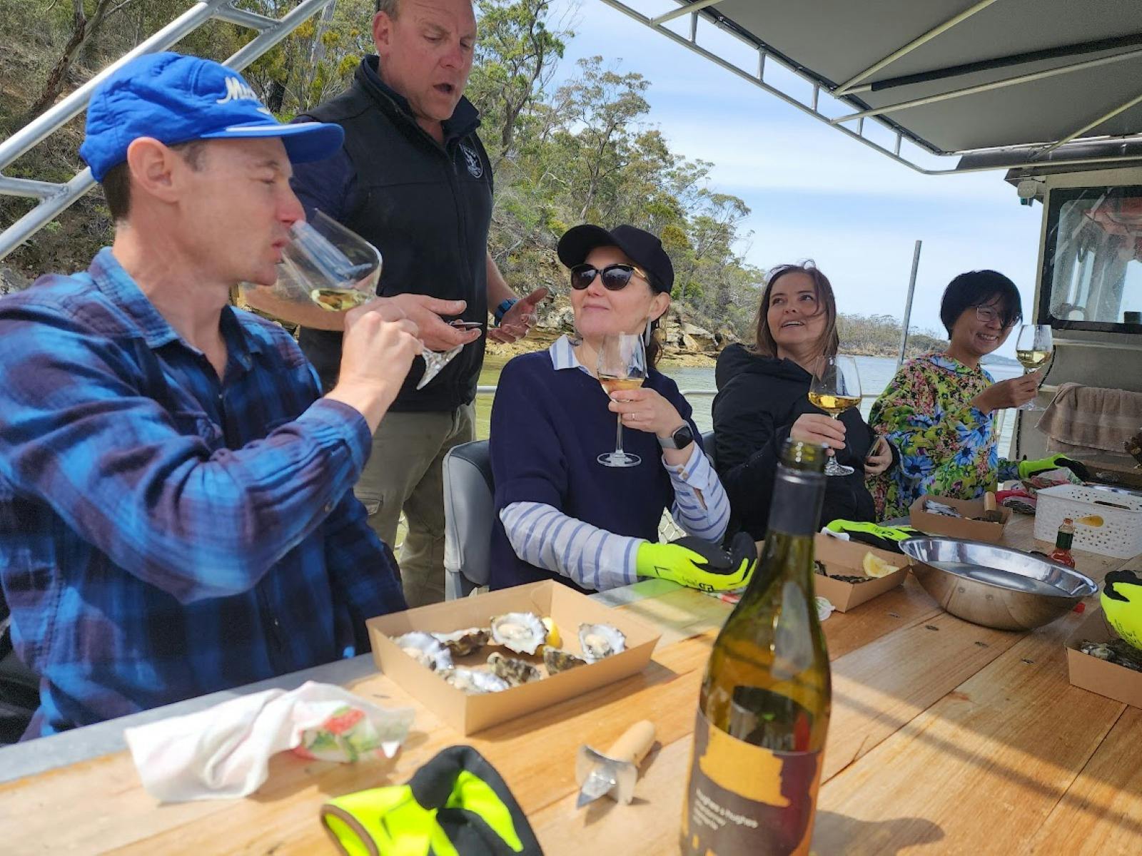 Guests raising glasses and shucking together
