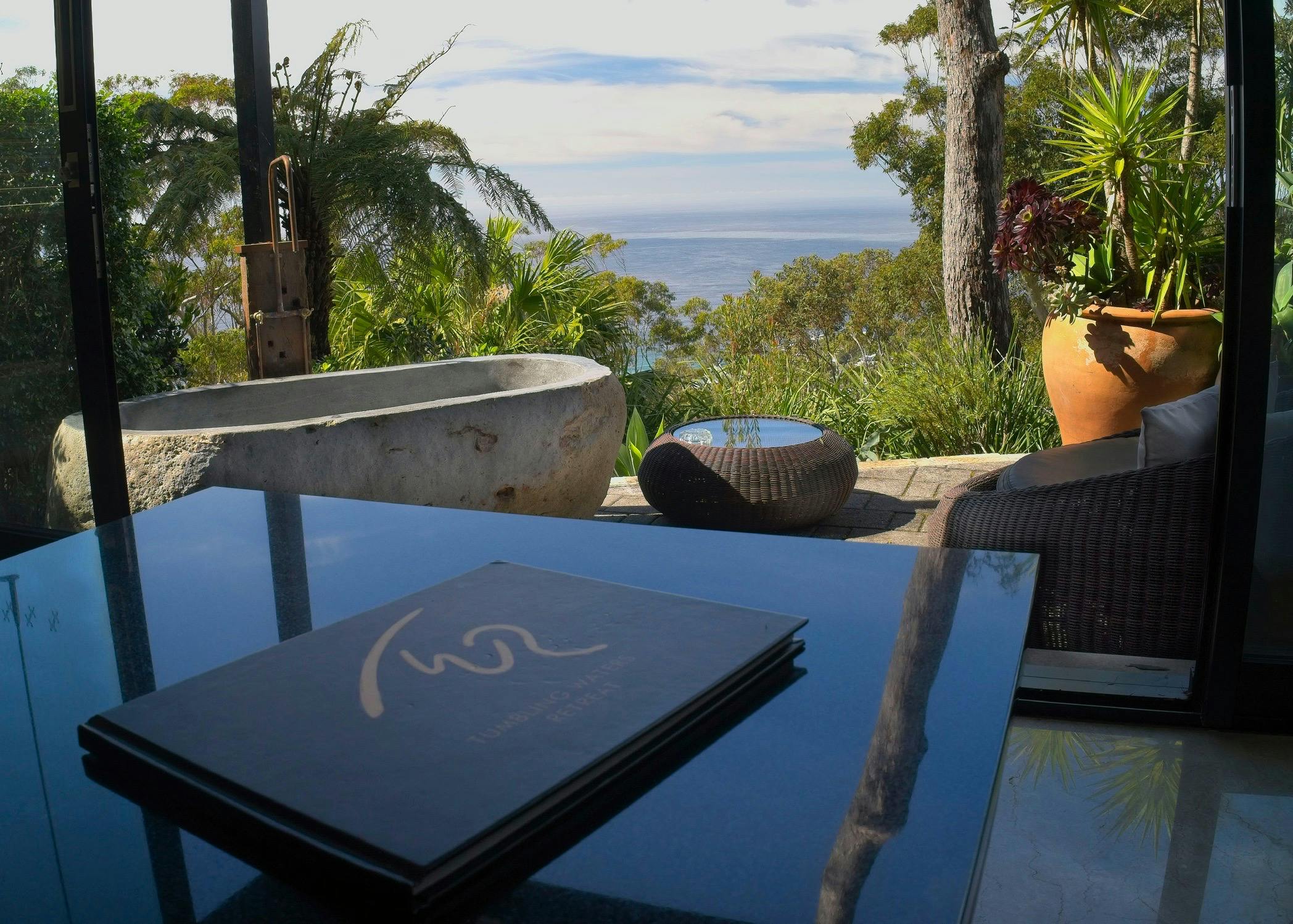 Relax overlooking the Ocean private stone baths designed for two.