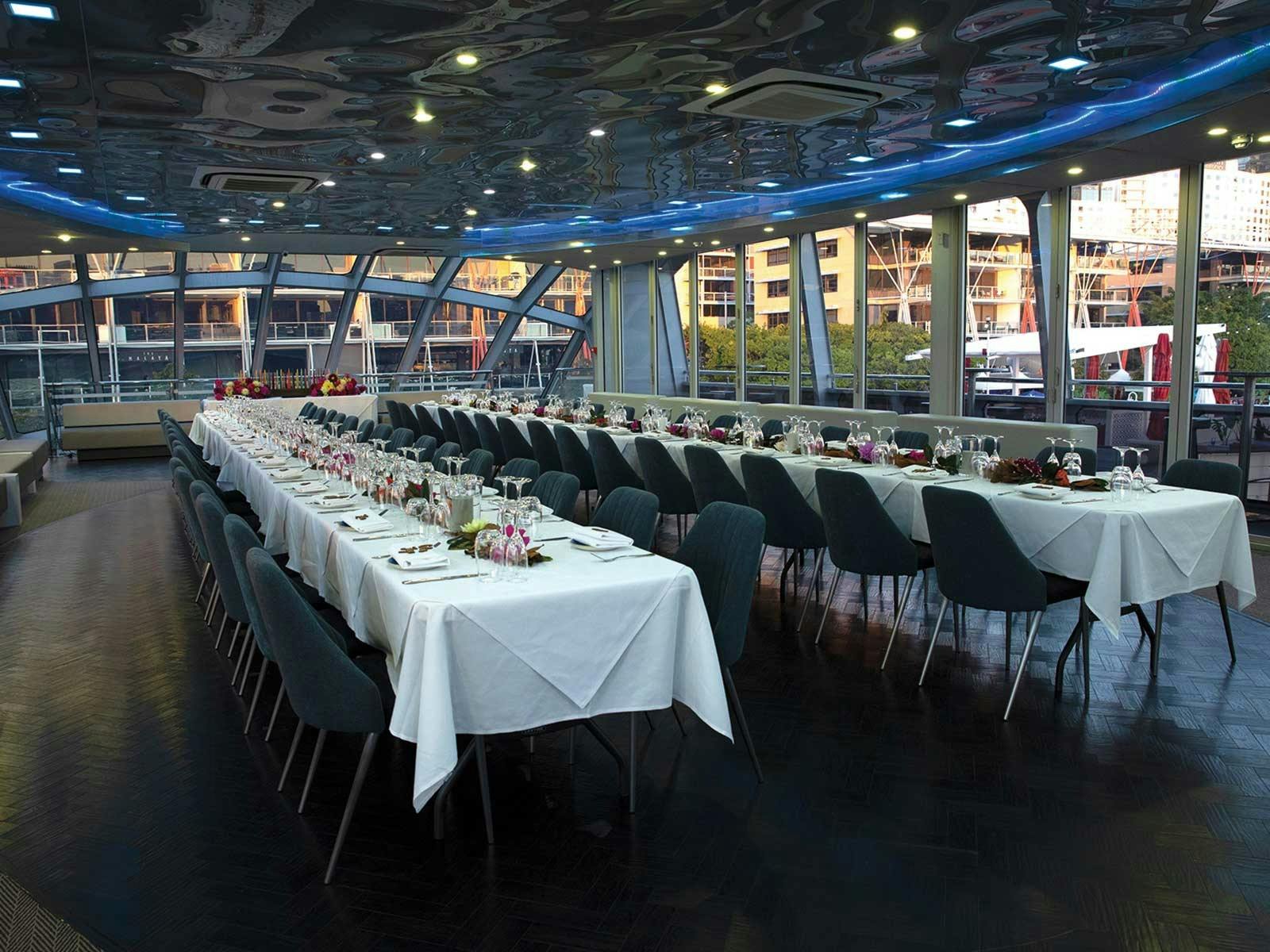 The glass-wrapped dining saloon of Clearview Glass Boat on Sydney Harbour