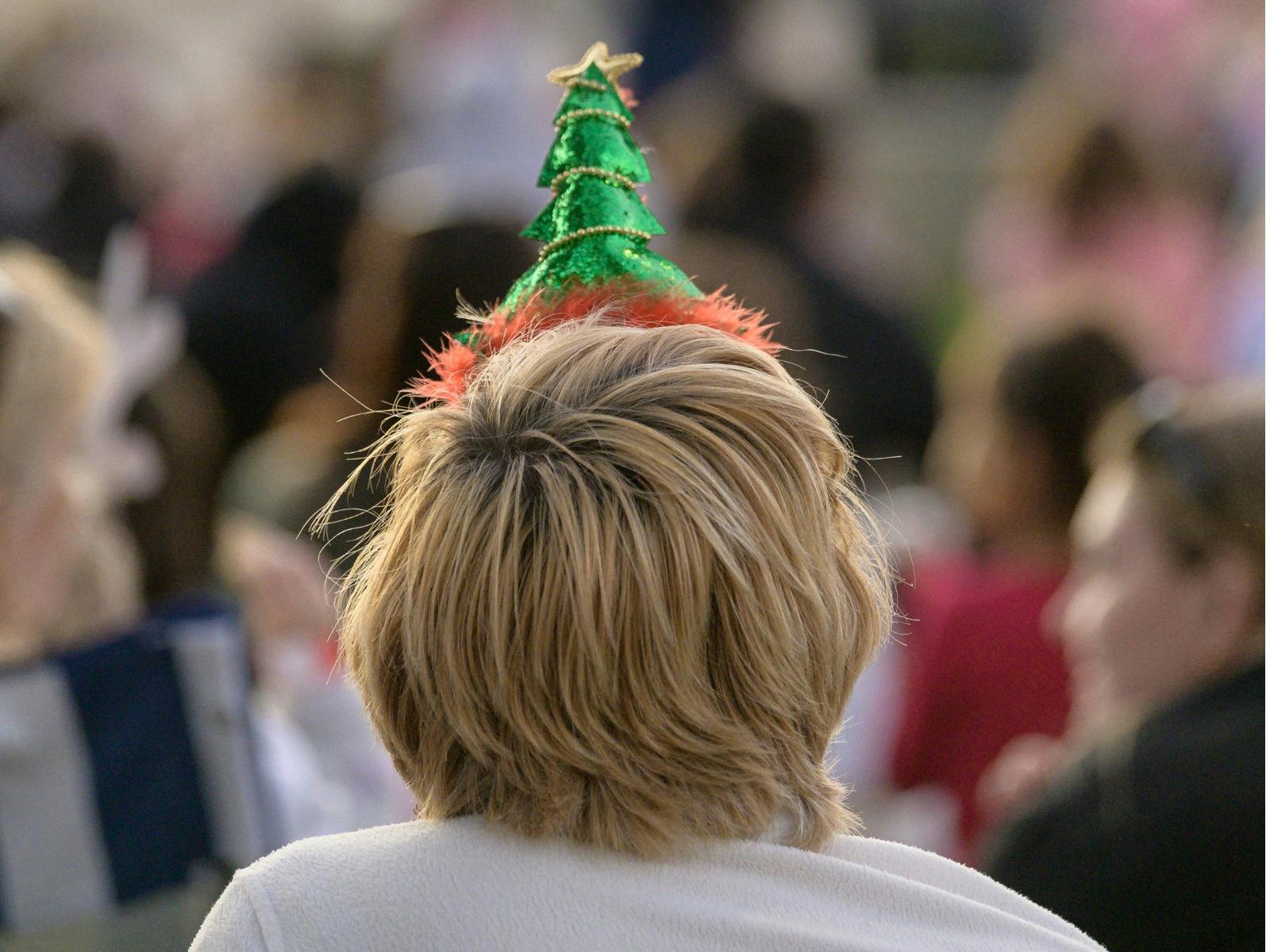 Child wearing Christmas Tree hat