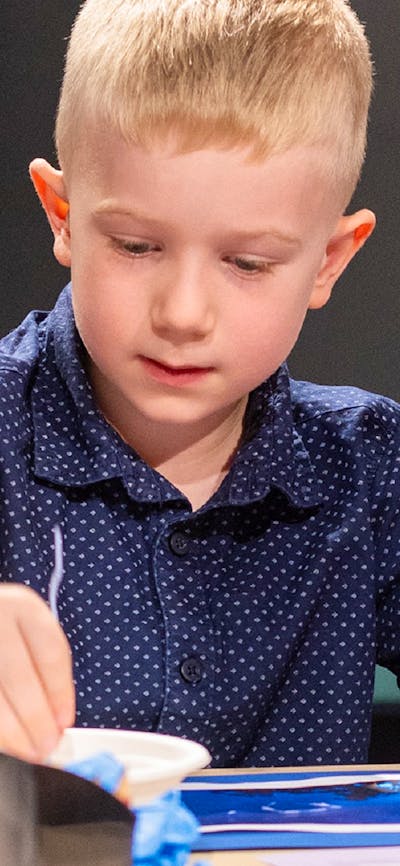 A child doing craft at a table