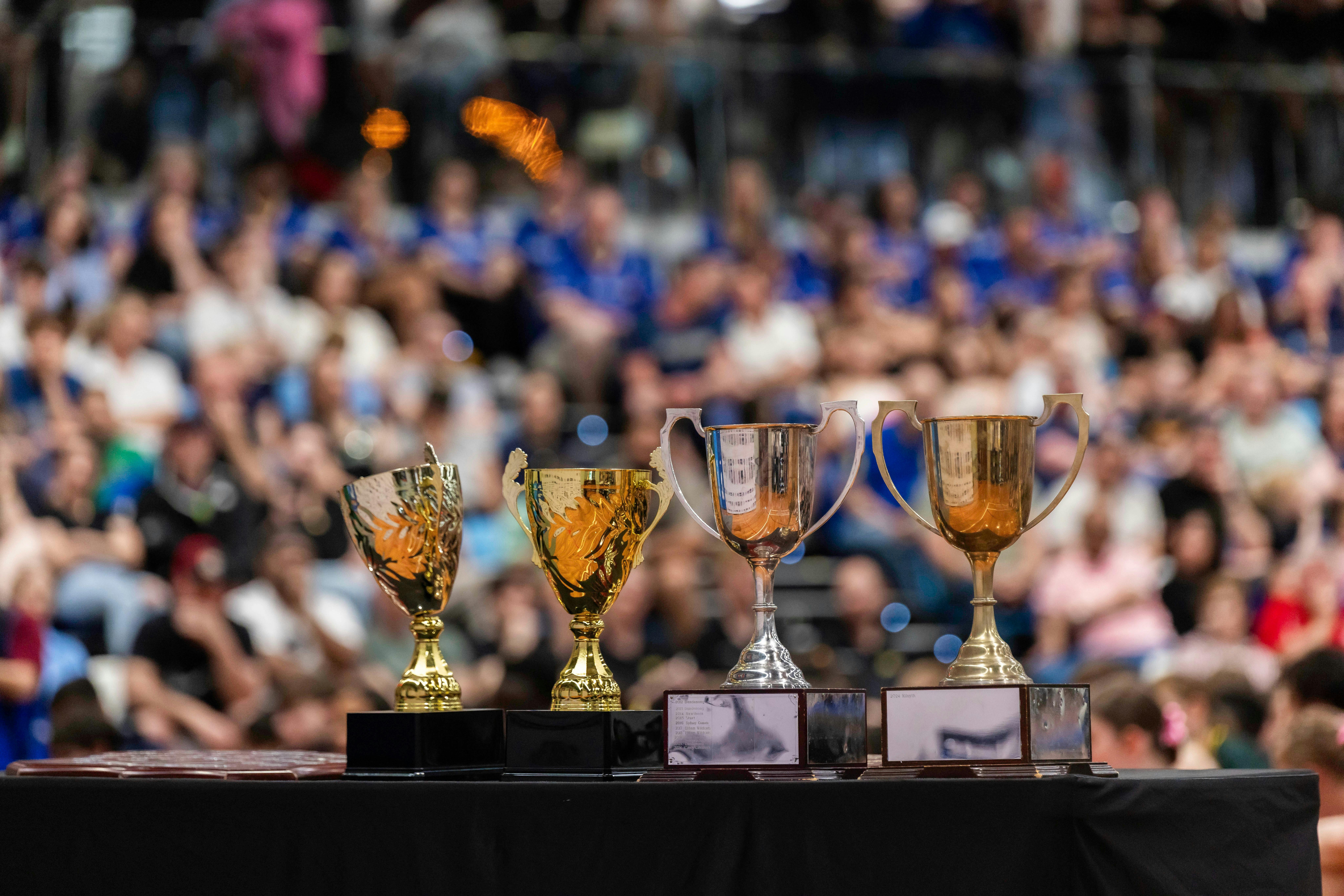 Trophies in foreground with crowd in background