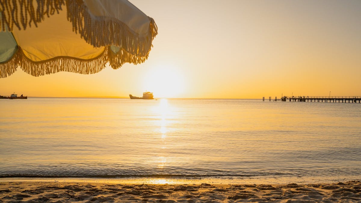 Sunset over the horizon, at the Kingfisher Bay jetty