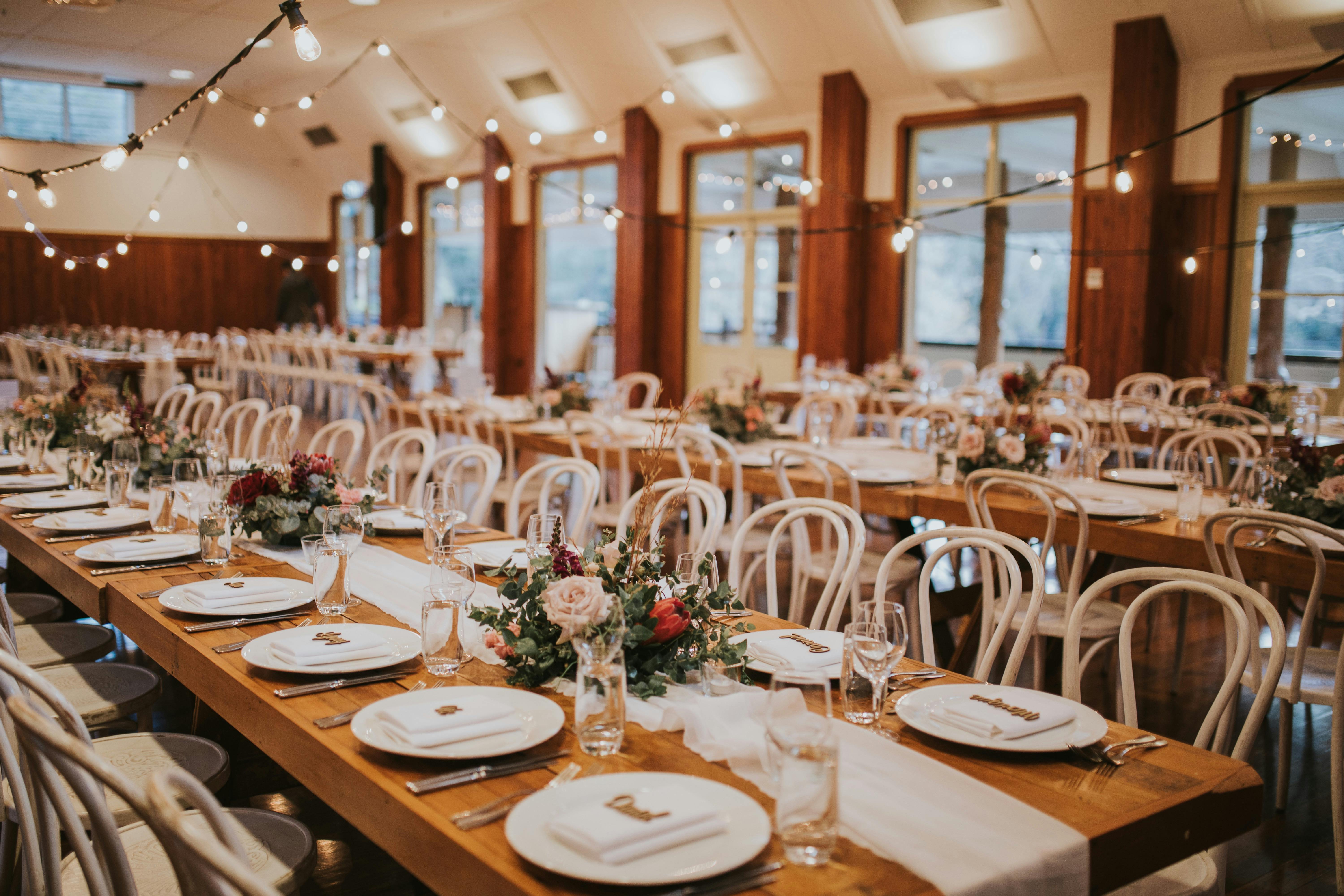 vintage timber tables set for a wedding in the original Audley dance hall