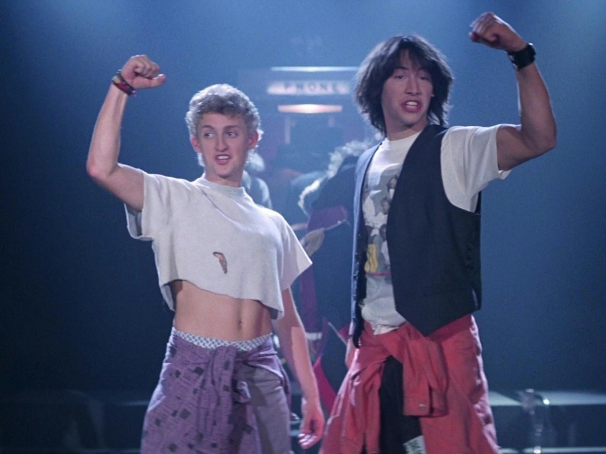 Still from Bill & Ted's Excellent Adventure showing two teenagers raising their fists