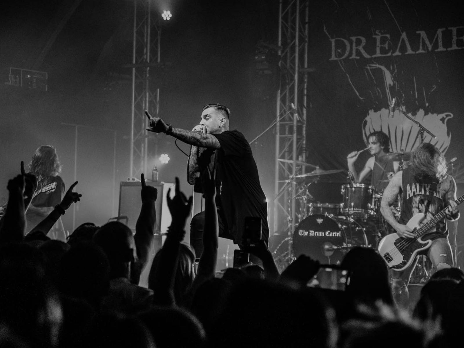 Dream On Dreamer band performing infront of a busy crowd from the crowd pov.