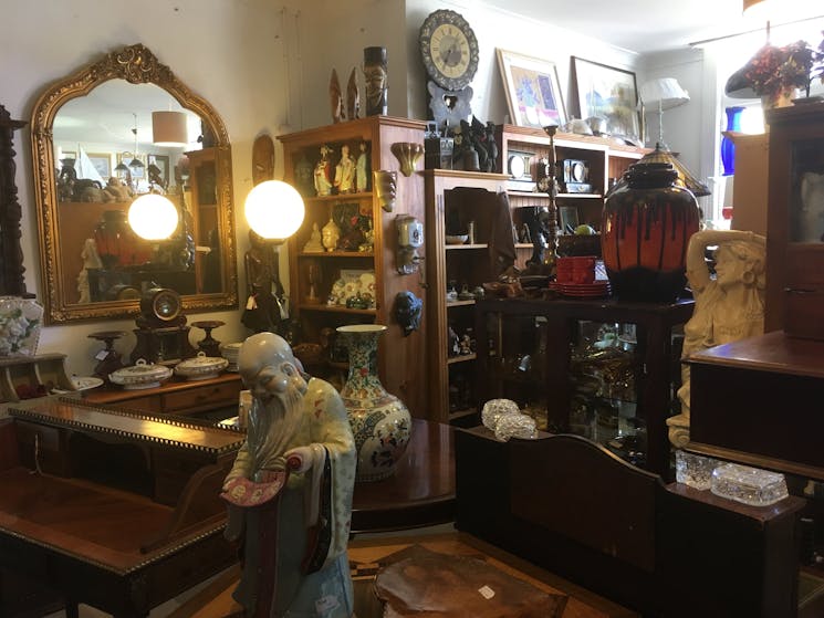 Downstairs shot of furniture, Asian artefacts, pottery, collectables