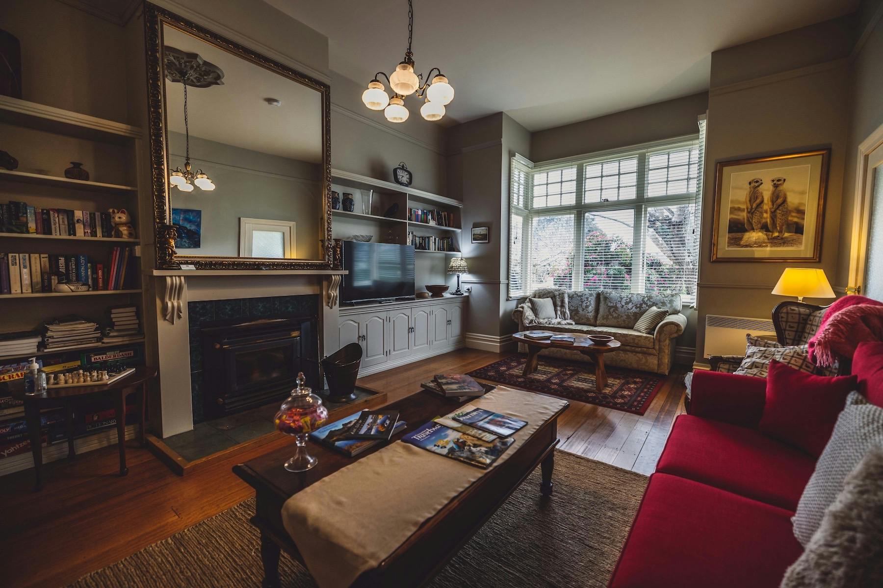 Guest lounge with log fire, books, television and comfortable seating at Glencoe