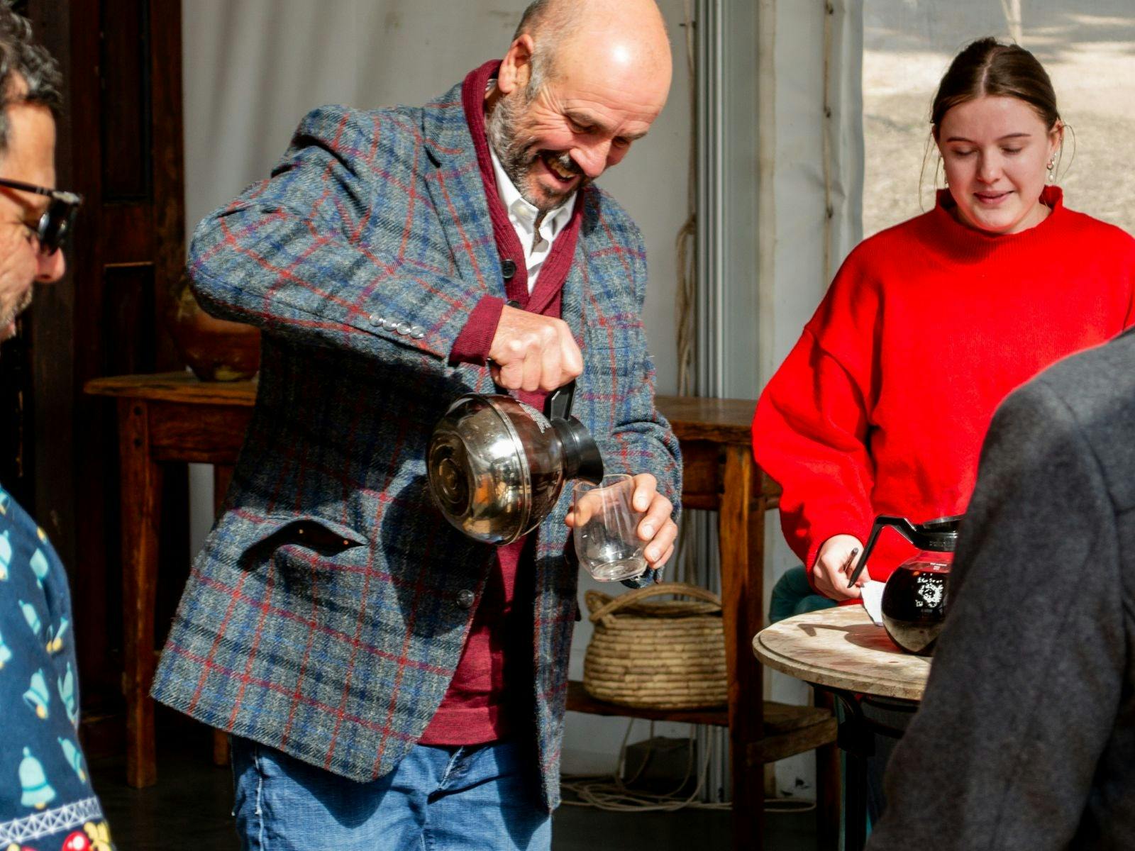 Jolly winemaker pouring mulled wine