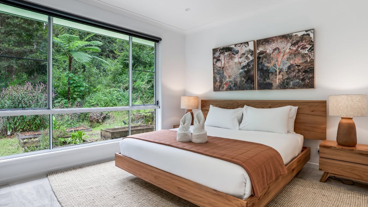 Main bedroom with ensuite bathroom and rainforest views