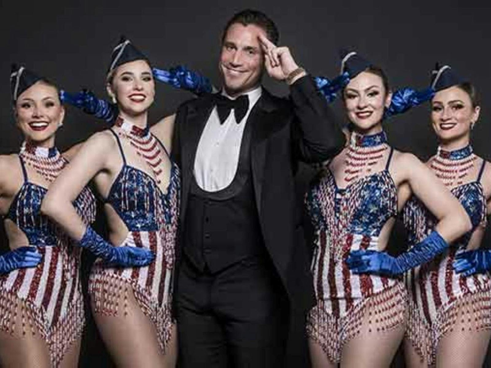 image of a man with lady's in american flag leotards