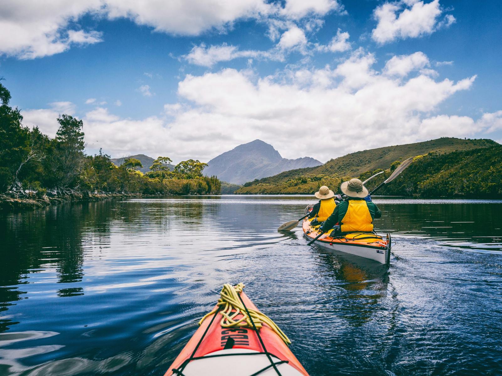 Kayakers paddling on Melaluca Inlet in Southwest Tasmania